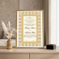Gold Arabesque Nikkah Frame Golden frame on console beside golden vase