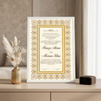 Gold Arabesque Nikkah Frame White frame on console beside golden vase